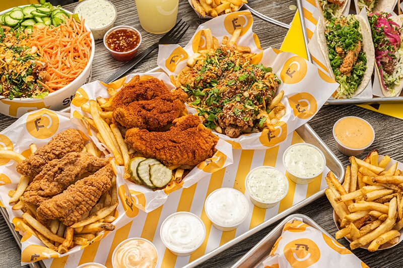 A medley of fried chicken and sauces on a table.
